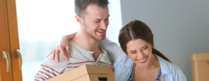 happy couple with moving boxes