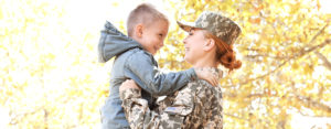 female veteran holding her son