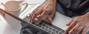 person typing on laptop computer