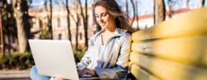 young woman on laptop in park