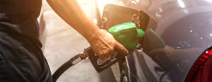 man filling car with gasoline